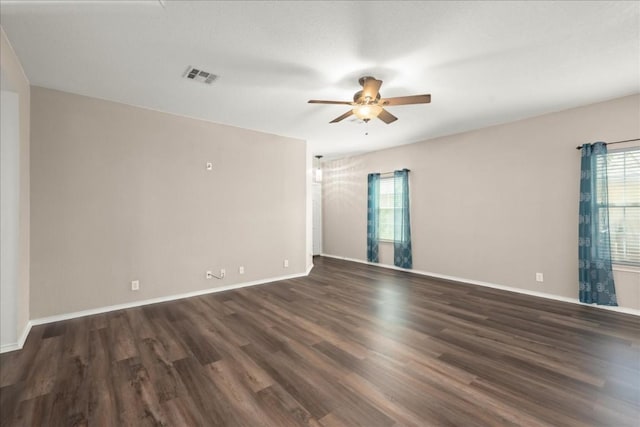 unfurnished room featuring ceiling fan and dark wood-type flooring