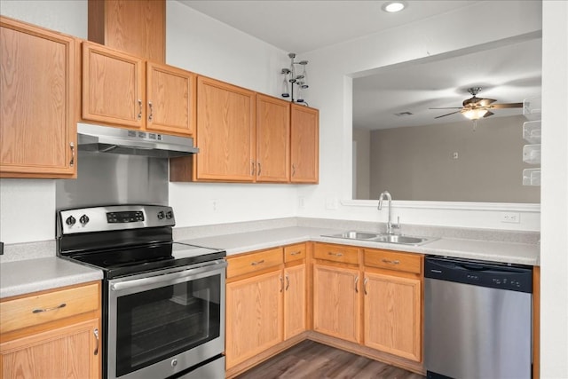 kitchen with appliances with stainless steel finishes, ceiling fan, sink, light brown cabinets, and dark hardwood / wood-style floors