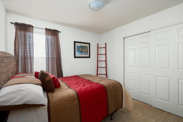 bedroom featuring light carpet and a closet