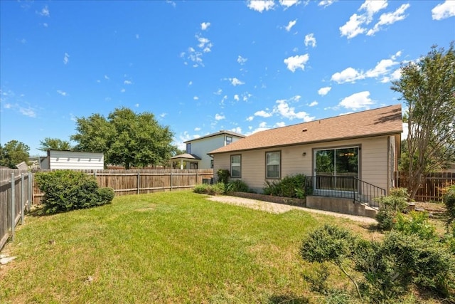 rear view of house with a lawn