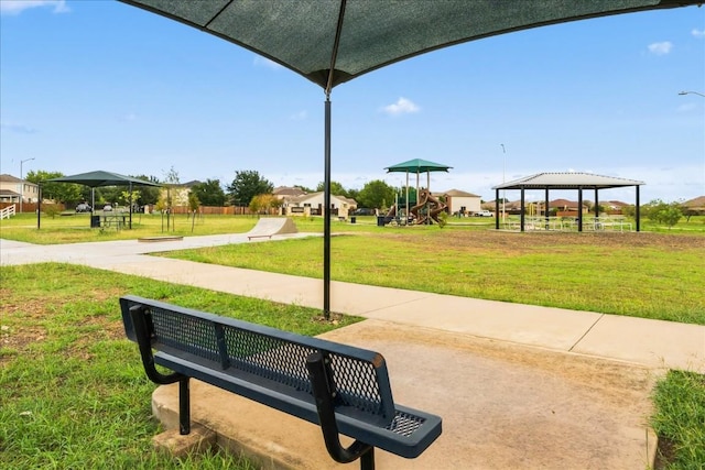 view of community featuring a gazebo, a playground, and a yard