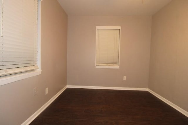 spare room featuring dark wood-type flooring