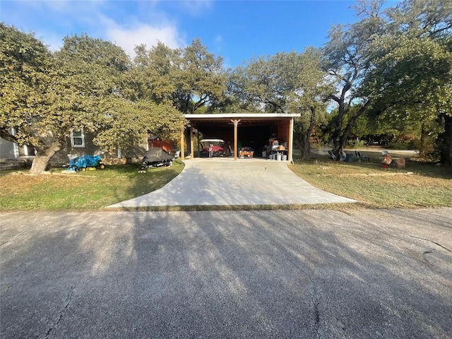 exterior space with a lawn and a carport