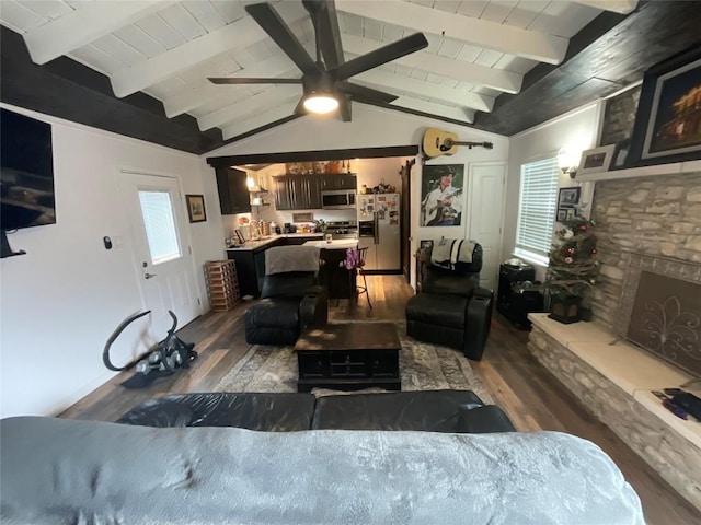 living room featuring ceiling fan, dark hardwood / wood-style flooring, lofted ceiling with beams, a fireplace, and wood ceiling