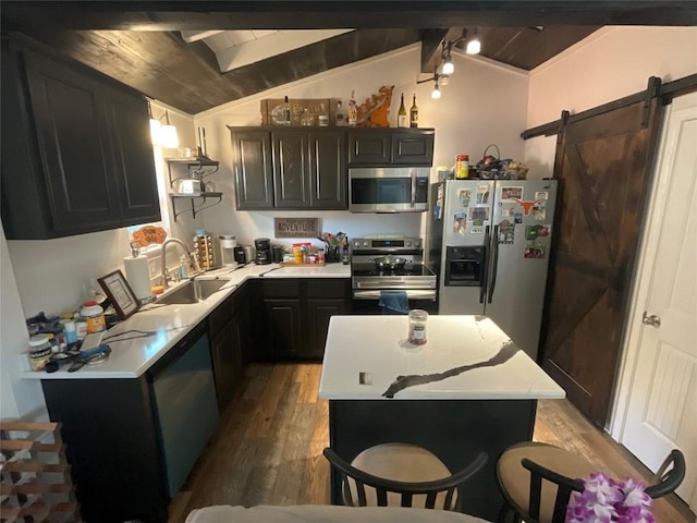 kitchen featuring appliances with stainless steel finishes, a barn door, lofted ceiling with beams, and wood ceiling