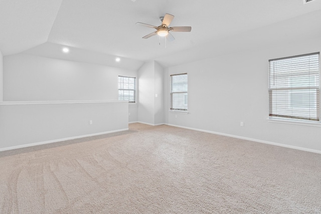 carpeted empty room featuring ceiling fan and vaulted ceiling