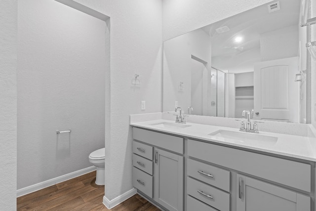 bathroom featuring hardwood / wood-style floors, vanity, and toilet