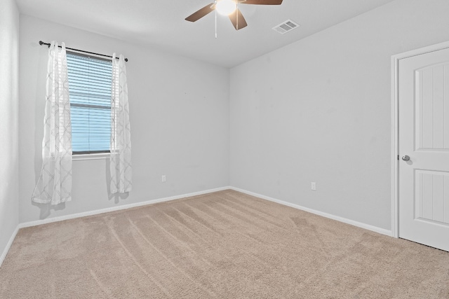 carpeted spare room featuring ceiling fan