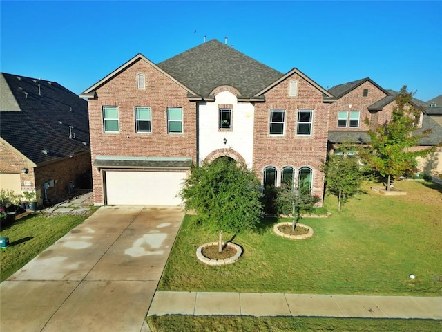 view of front of home featuring a front yard and a garage