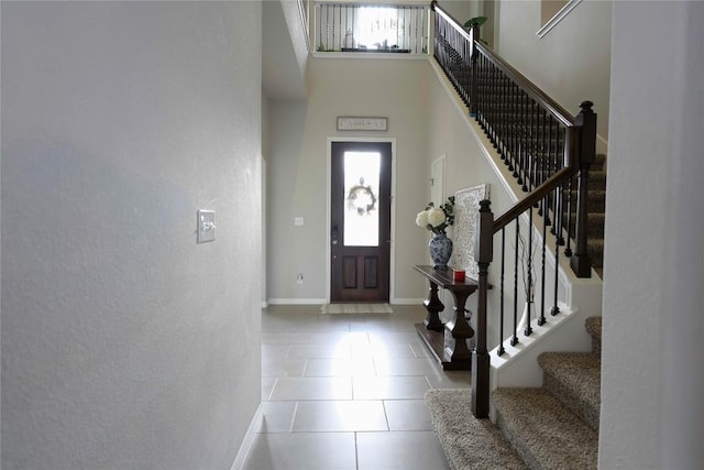 tiled foyer entrance featuring a high ceiling