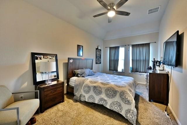 carpeted bedroom with ceiling fan and vaulted ceiling