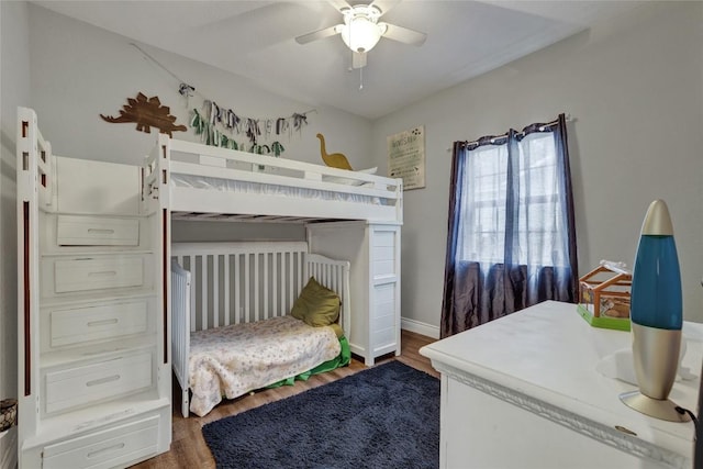 bedroom with dark hardwood / wood-style flooring and ceiling fan