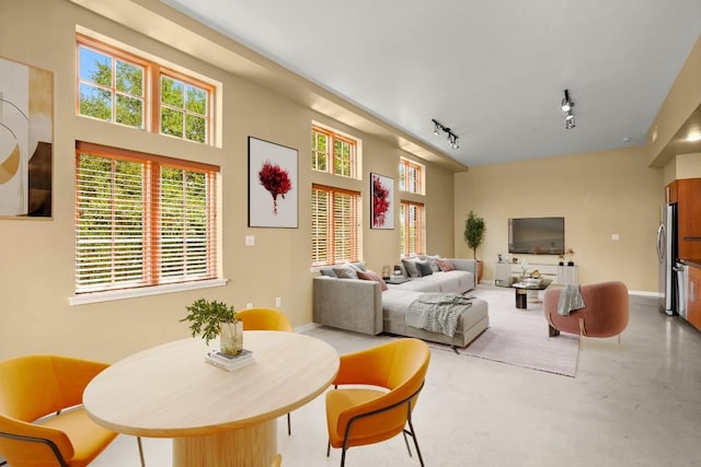 living room with concrete floors and track lighting