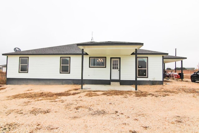 view of front of property featuring covered porch and a carport