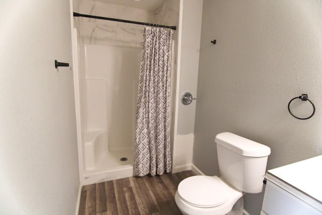 bathroom with toilet, wood-type flooring, vanity, and a shower with curtain