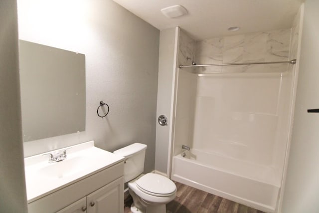 full bathroom with toilet, vanity, bathtub / shower combination, and hardwood / wood-style flooring