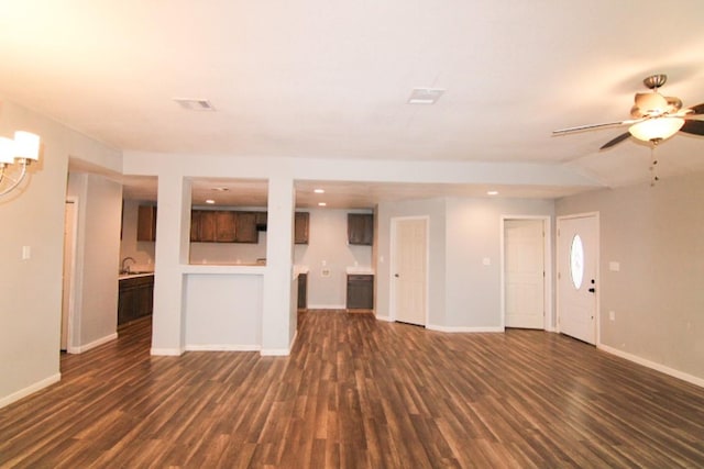 unfurnished living room with ceiling fan, dark hardwood / wood-style flooring, and sink