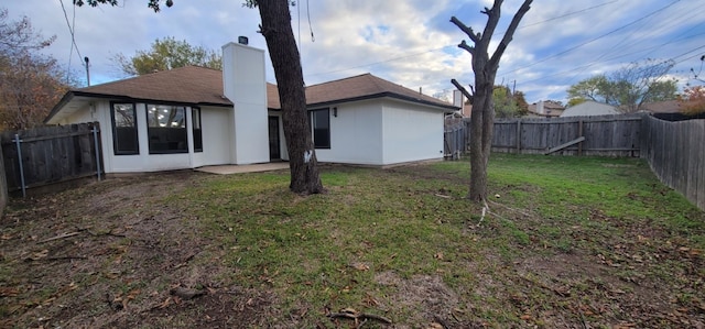 rear view of house with a yard