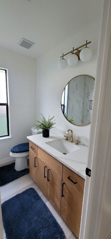 bathroom featuring tile patterned floors, vanity, and toilet