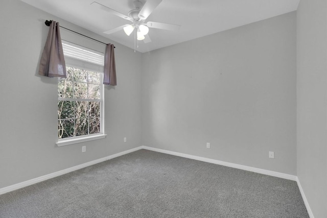 empty room featuring a ceiling fan, carpet, and baseboards