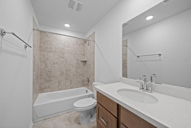 full bathroom featuring vanity, tiled shower / bath combo, and toilet