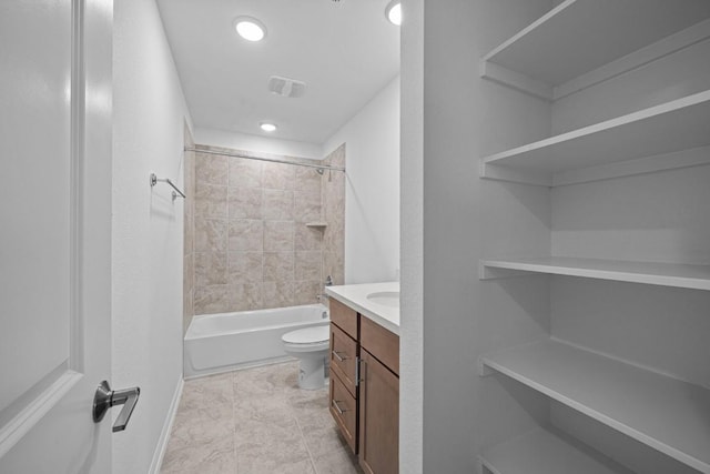 full bathroom featuring vanity, toilet, and tiled shower / bath combo