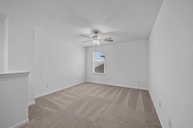 empty room featuring carpet flooring and ceiling fan