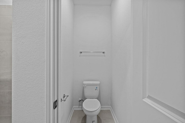 bathroom with tile patterned flooring and toilet