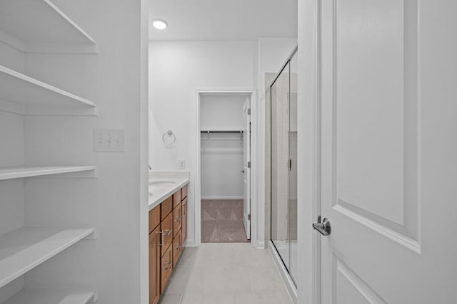 bathroom featuring vanity and an enclosed shower