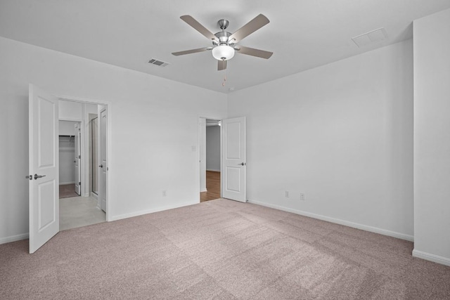 unfurnished bedroom with ceiling fan and light carpet