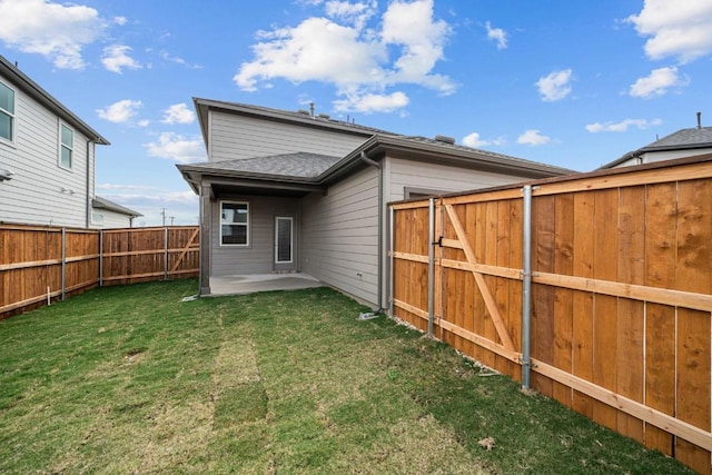 back of house featuring a lawn and a patio