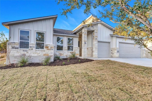 view of front of property with a garage and a front lawn