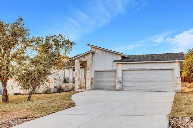 view of front of house with a garage and a front lawn