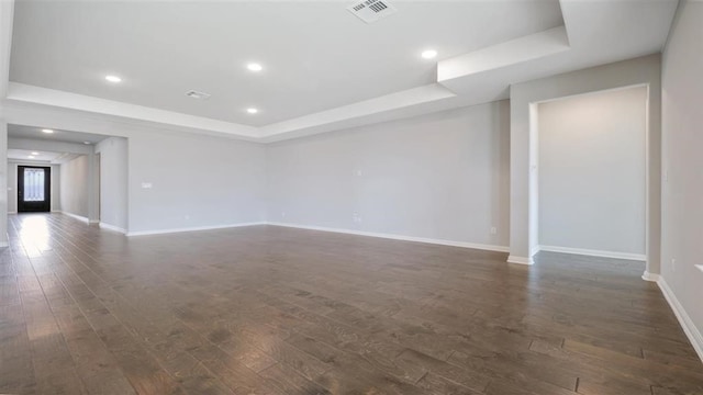 unfurnished room featuring a raised ceiling, dark hardwood / wood-style flooring, and french doors