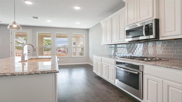 kitchen with white cabinets, stainless steel appliances, and sink