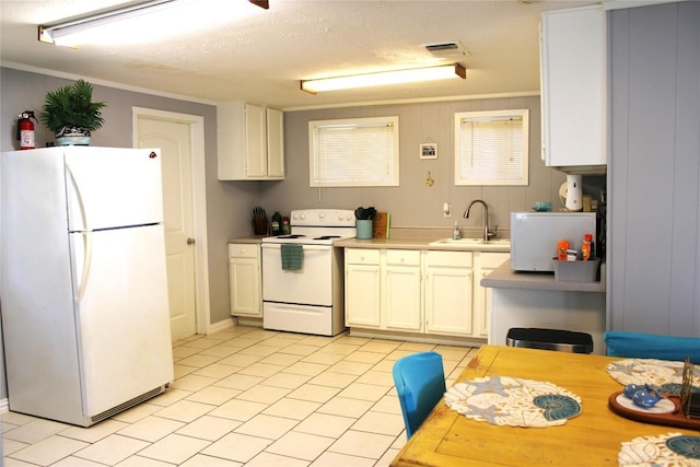 kitchen featuring white appliances, crown molding, sink, a textured ceiling, and white cabinetry