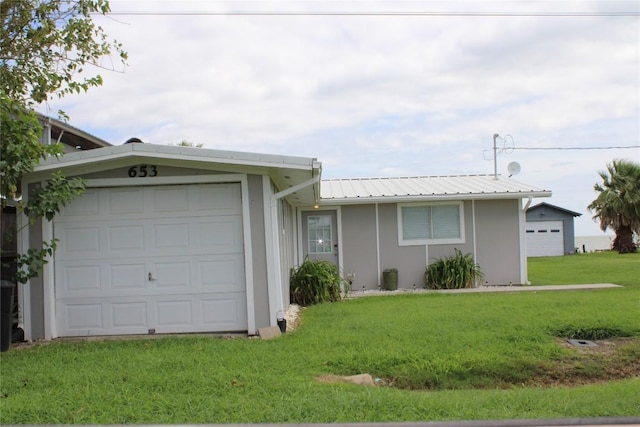 single story home featuring a front yard and a garage