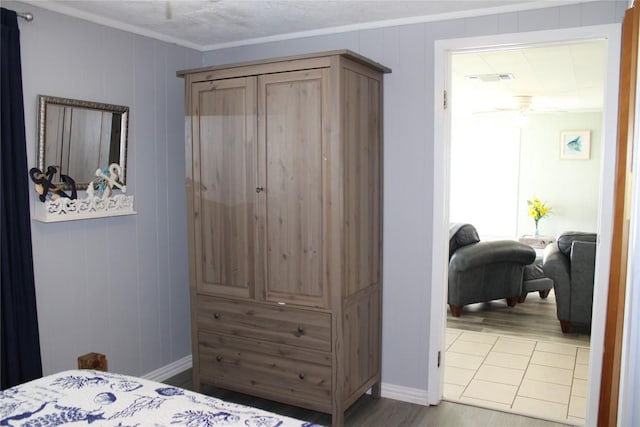 bedroom with crown molding and wood-type flooring