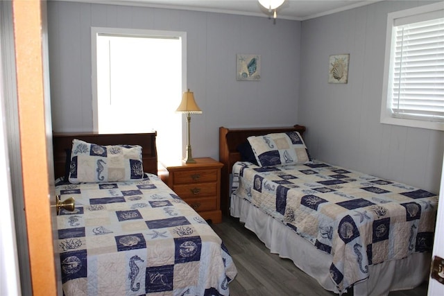 bedroom with dark hardwood / wood-style floors and crown molding