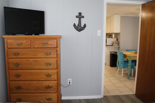 interior details featuring hardwood / wood-style flooring and wooden walls