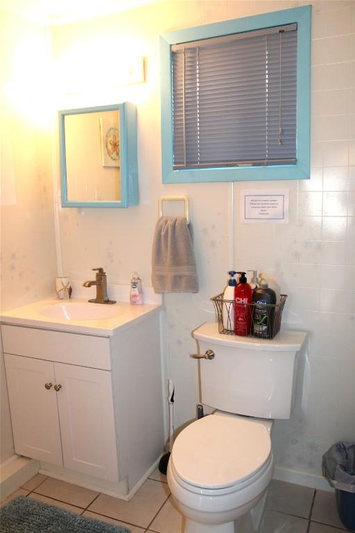 bathroom with tile patterned floors, vanity, and toilet