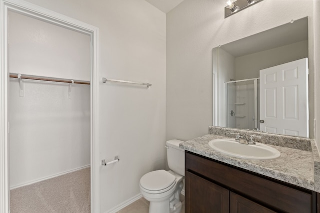 bathroom with vanity, toilet, and walk in shower