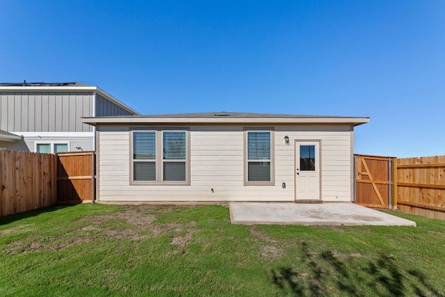 back of property featuring a patio area and a lawn