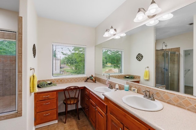 bathroom featuring vanity, tile patterned floors, walk in shower, and a healthy amount of sunlight