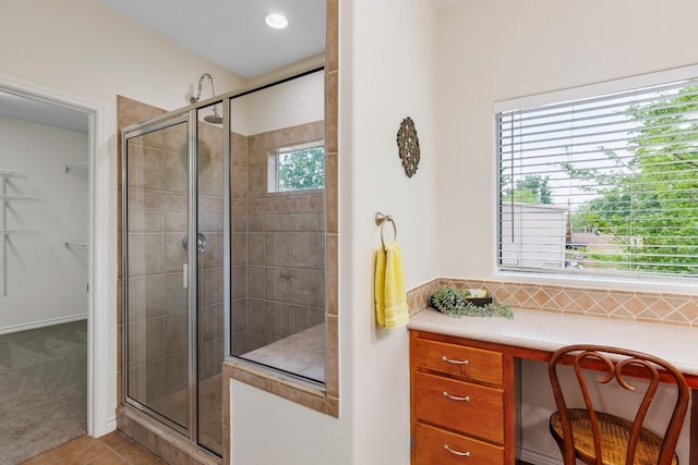 bathroom featuring tile patterned floors and a shower with shower door