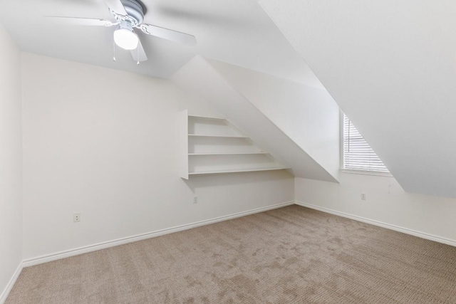 bonus room featuring ceiling fan, light colored carpet, and vaulted ceiling