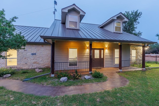 view of front of home featuring covered porch and a front yard