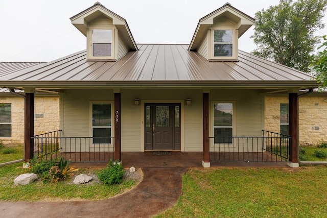 view of front facade with covered porch and a front yard