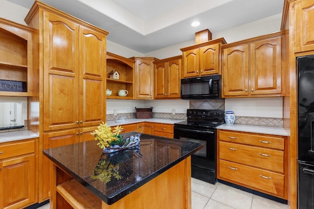 kitchen with a center island, backsplash, dark stone counters, black appliances, and light tile patterned floors