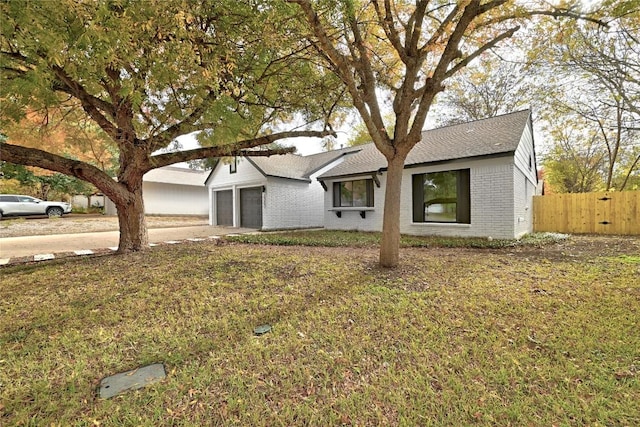 ranch-style home featuring a garage and a front yard